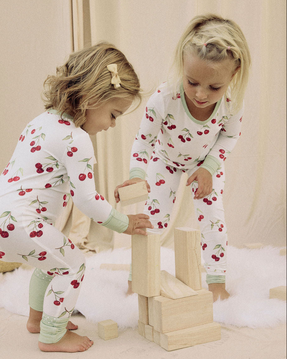 Two children in matching Market Cherries Onesie